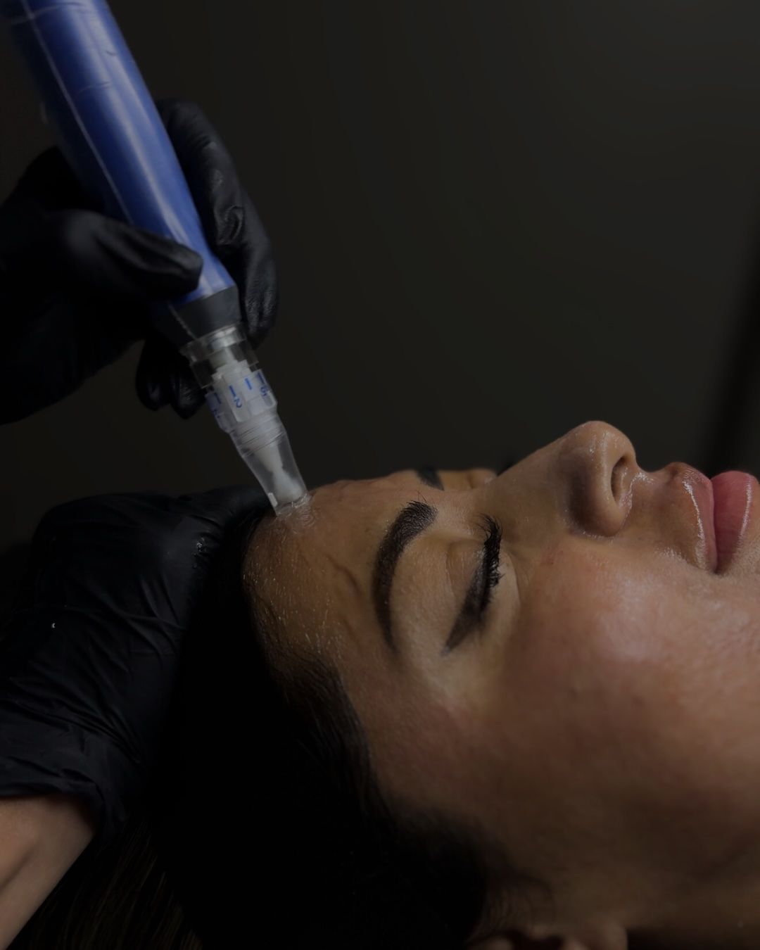 Woman with long dark hair and soft smile.