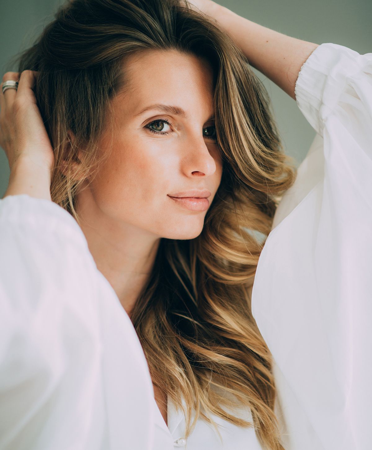 Woman with long hair in white blouse.