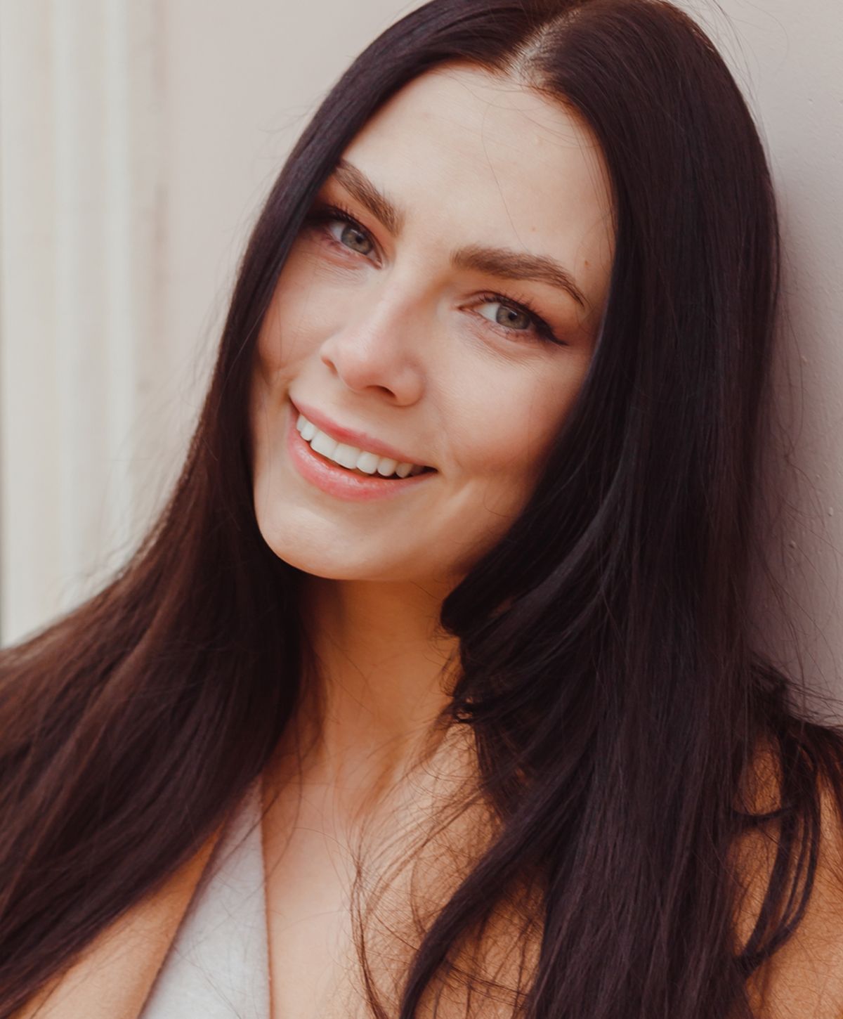 Smiling woman with long dark hair.