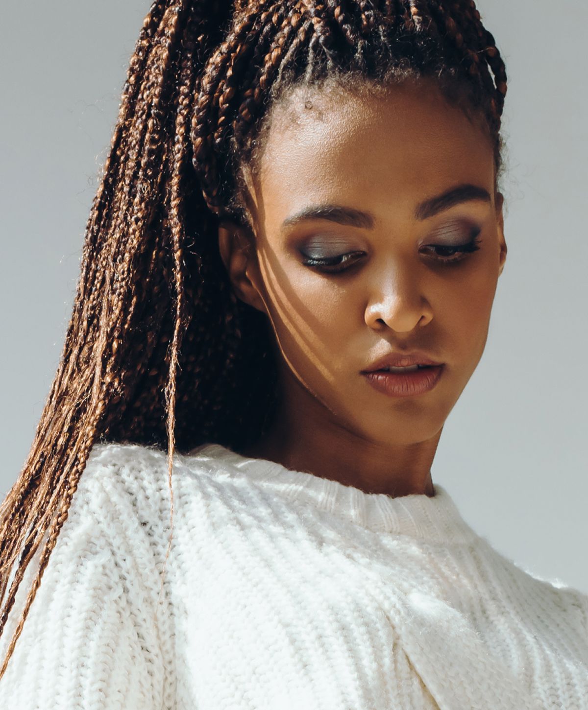 Smiling woman with long black hair outdoors.