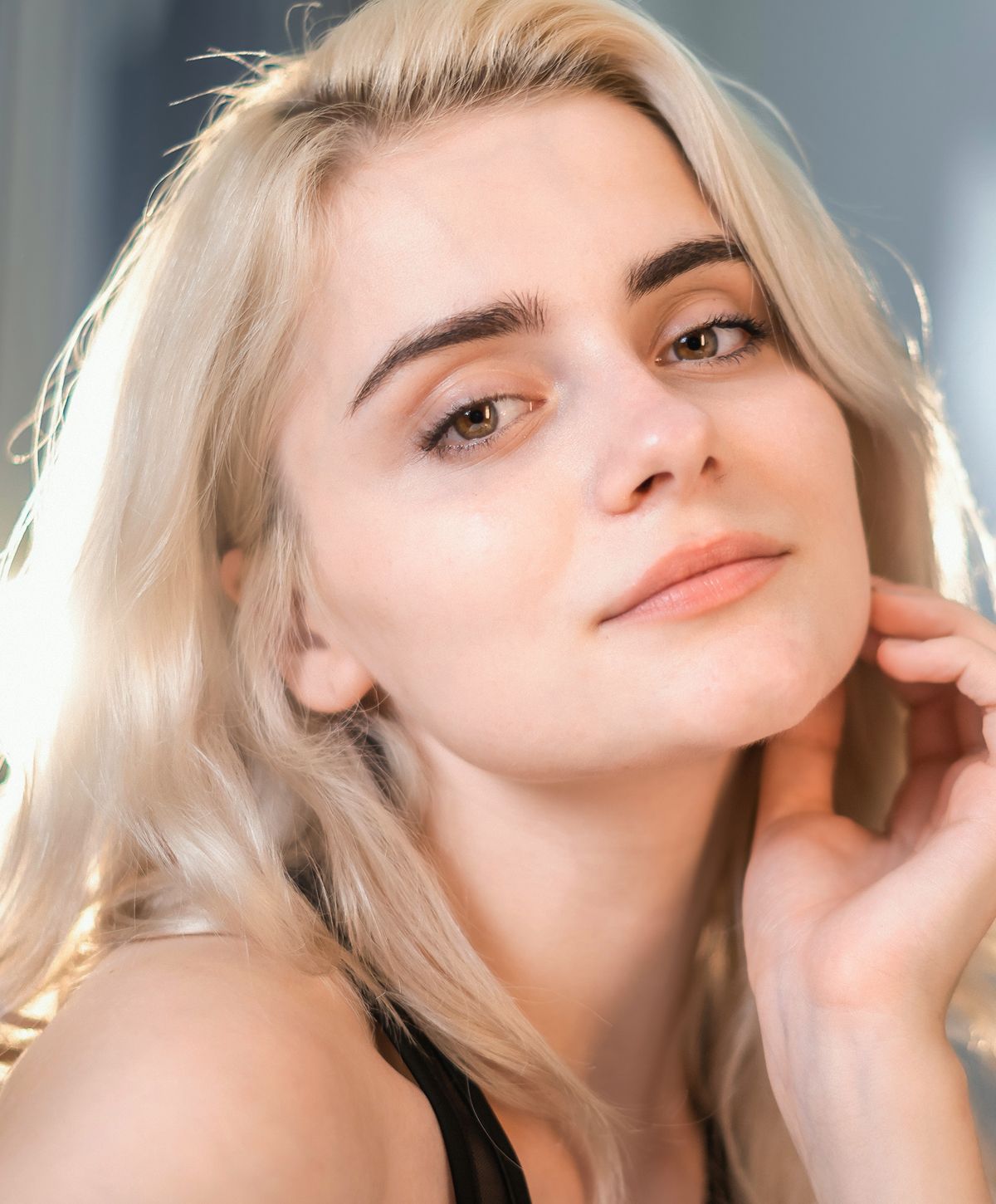 Woman with long hair looking back over shoulder.
