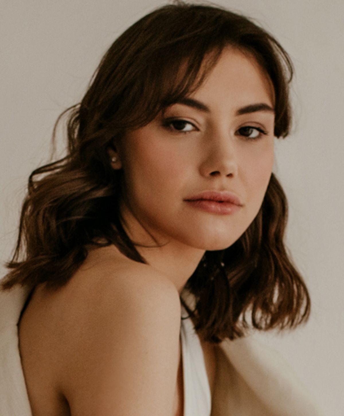 Young woman with blonde hair, soft expression.