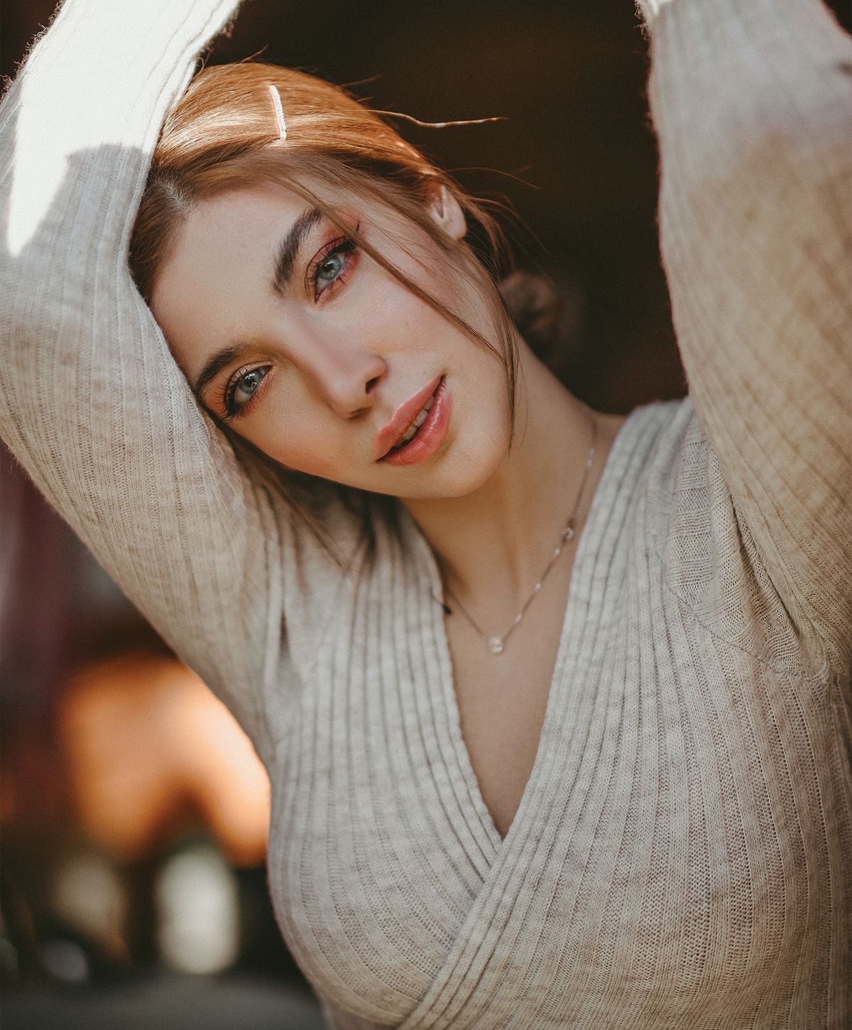 Woman with soft smile and natural lighting.
