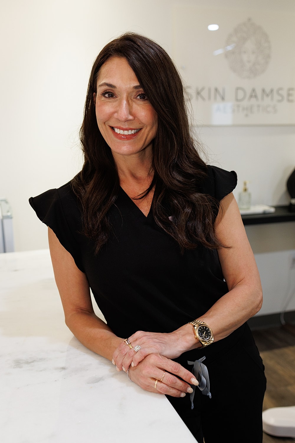 Professional woman with crossed arms and smile.