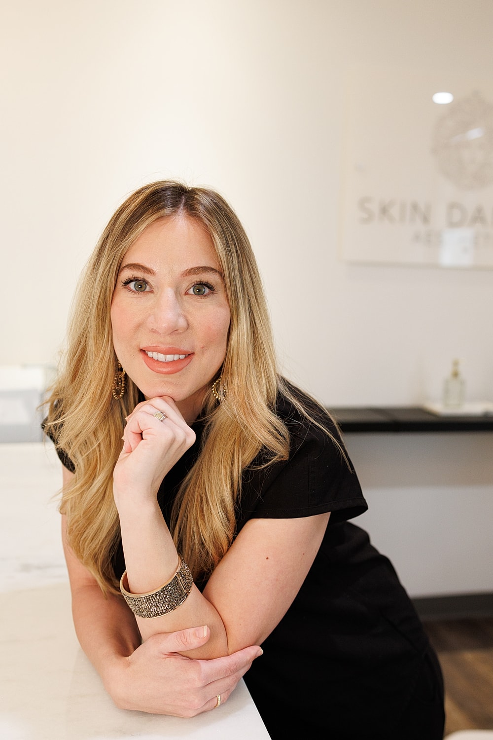 Smiling woman in a skincare clinic setting.