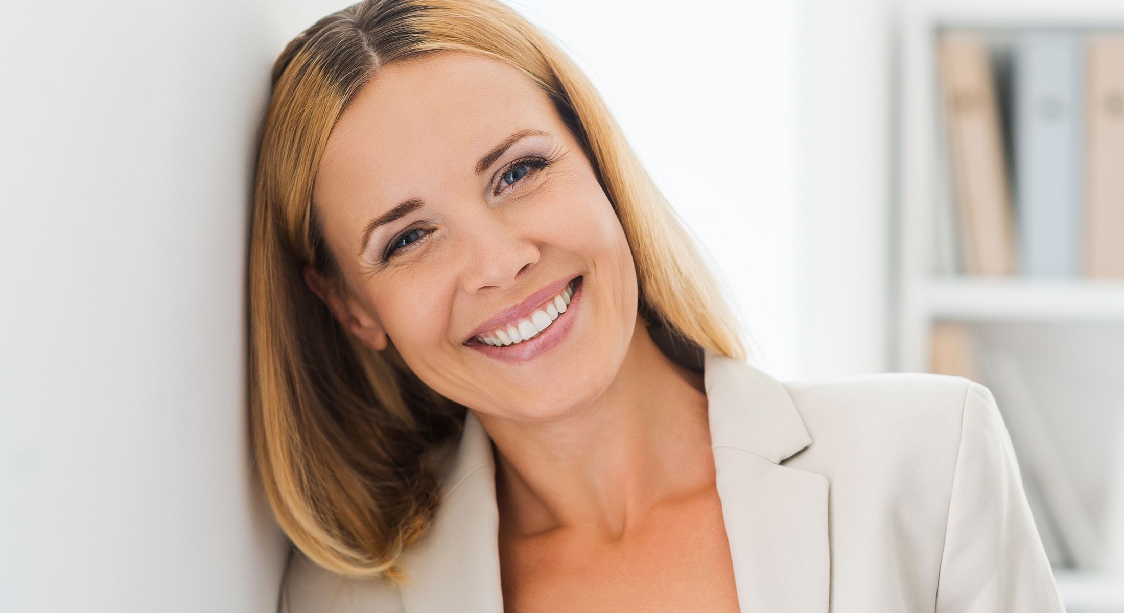 Person with curly hair and natural makeup.