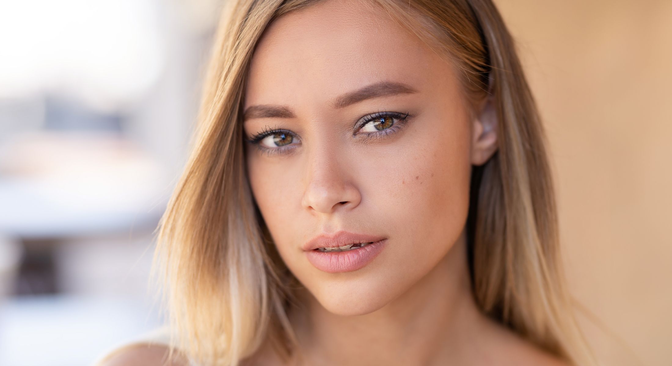Close-up portrait of a woman with blonde hair.