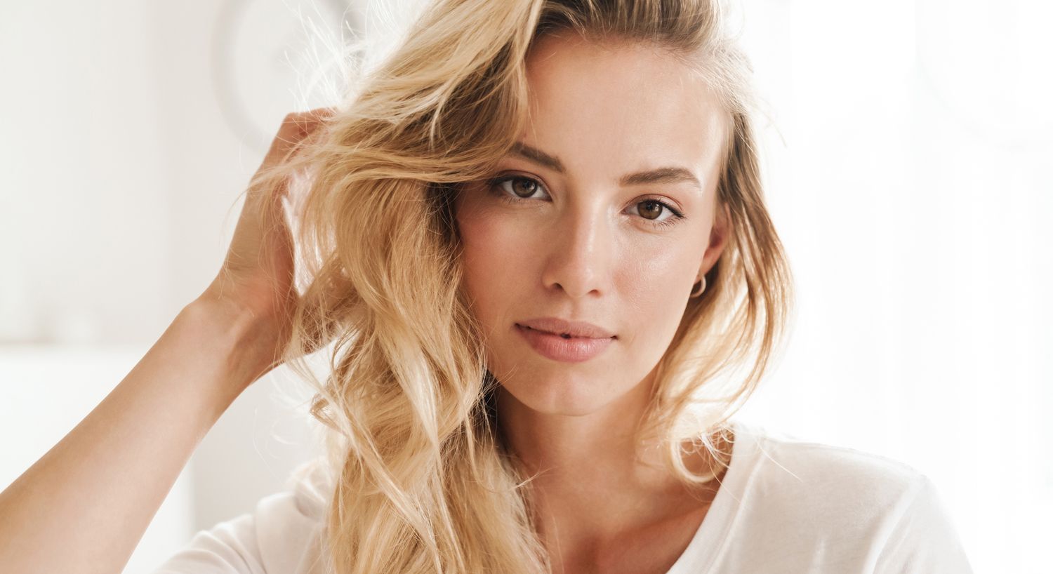 Woman with long hair in white off-shoulder top.