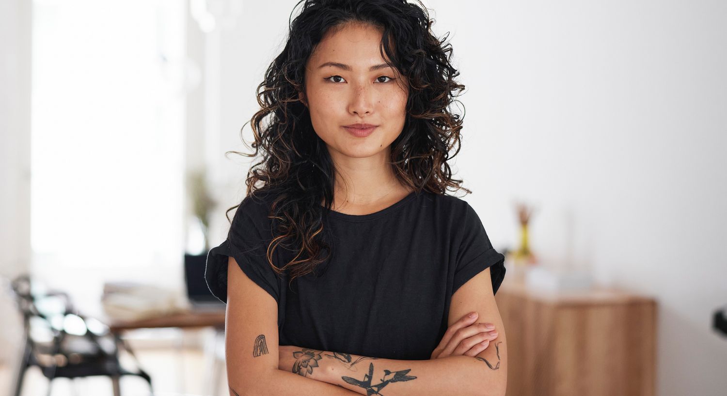 Smiling woman in professional setting, blonde hair.